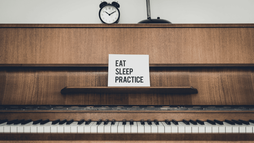 Piano with a sign that says eat, sleep, practice