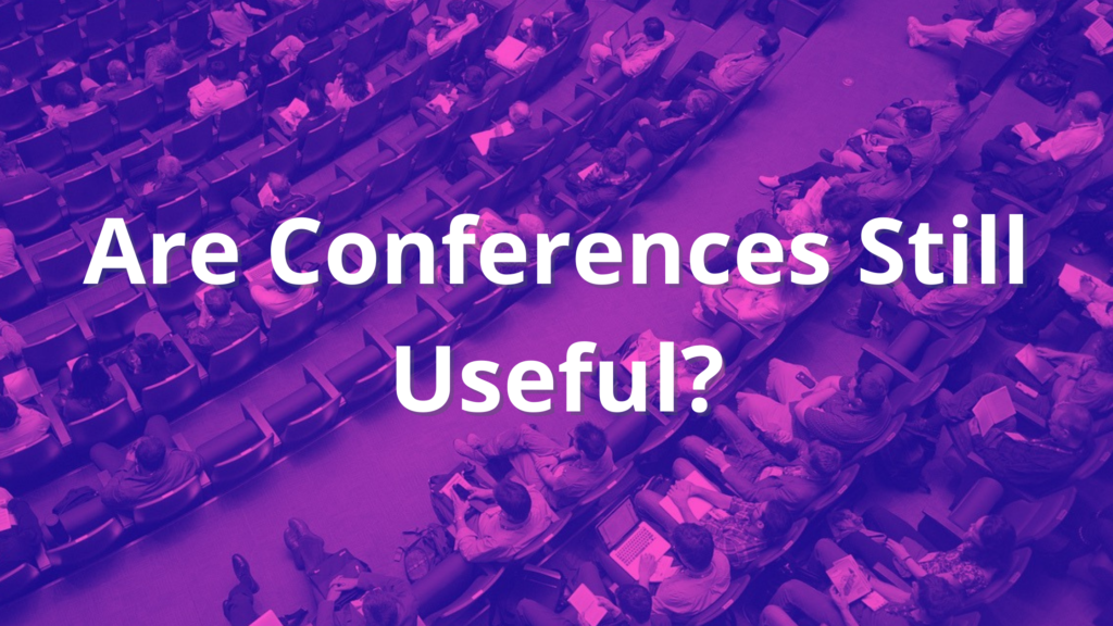Picture of conference attendees and text: Are Conferences Still Useful?