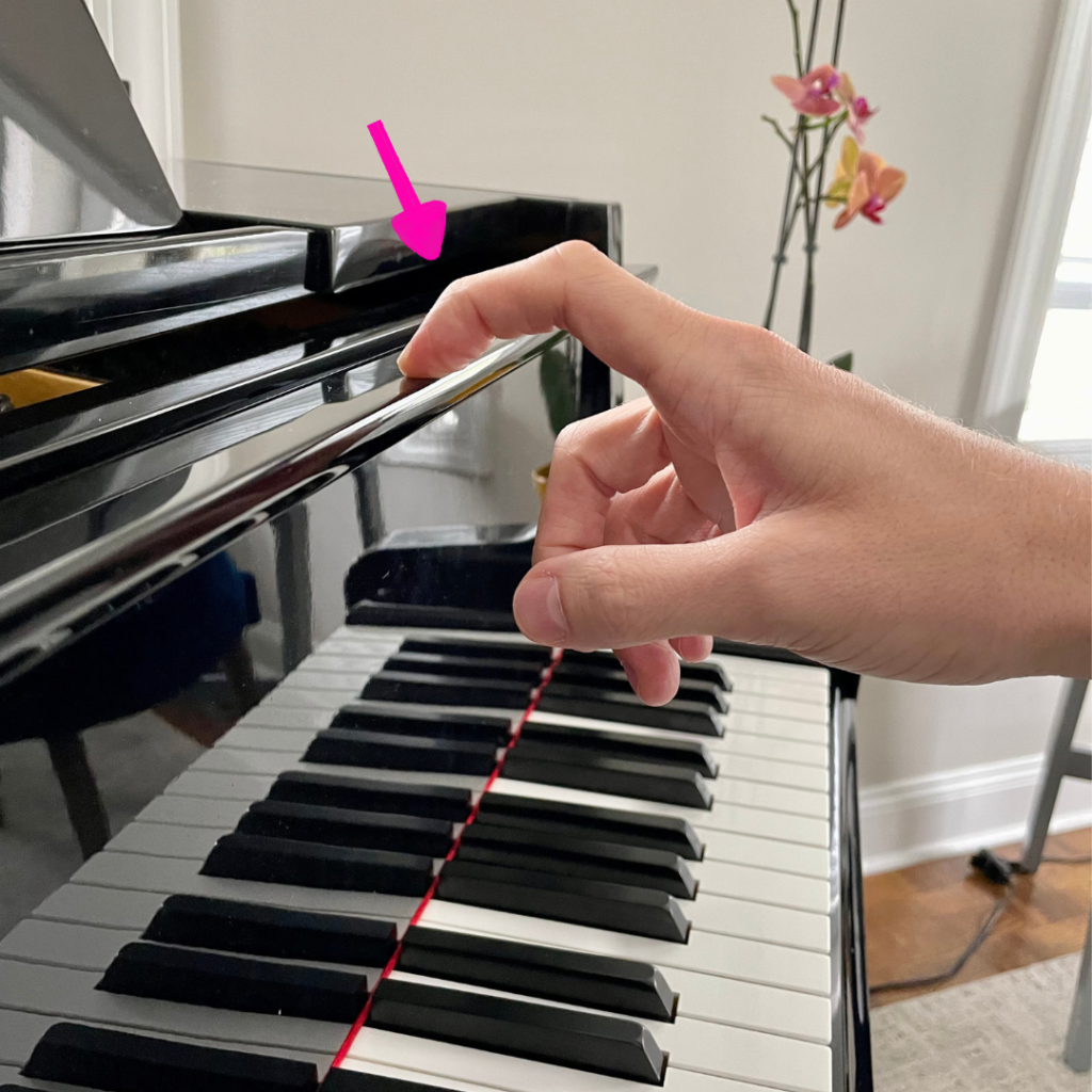 Hanging a finger off of the piano fallboard 