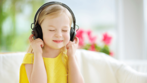 Girl in yellow dress listening to music with head phones
