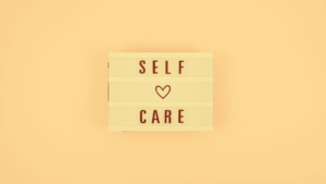 Self care text with tiny heart in middle